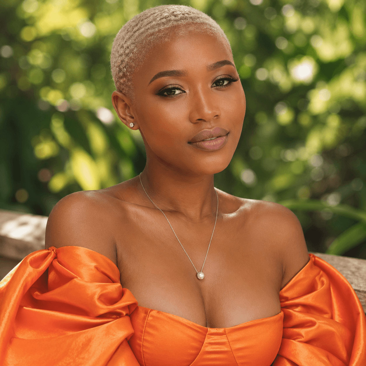 Outdoor portrait of a woman wearing an orange dress